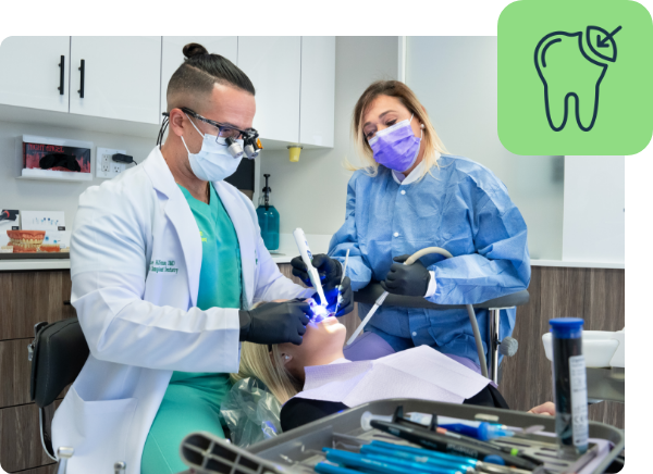 Dentist and nurse performing an intervention on a patient